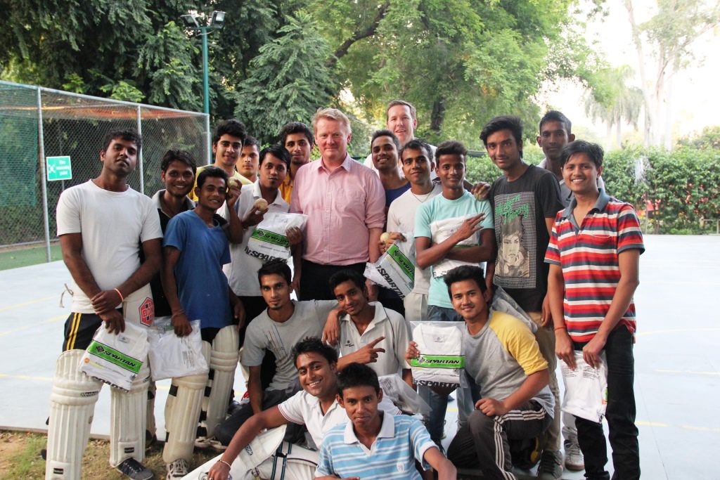 Australian Deputy High Commissioner, Mr Bernard Philip presents uniform t-shirts to the Asha students during a practice session organised earlier this month.