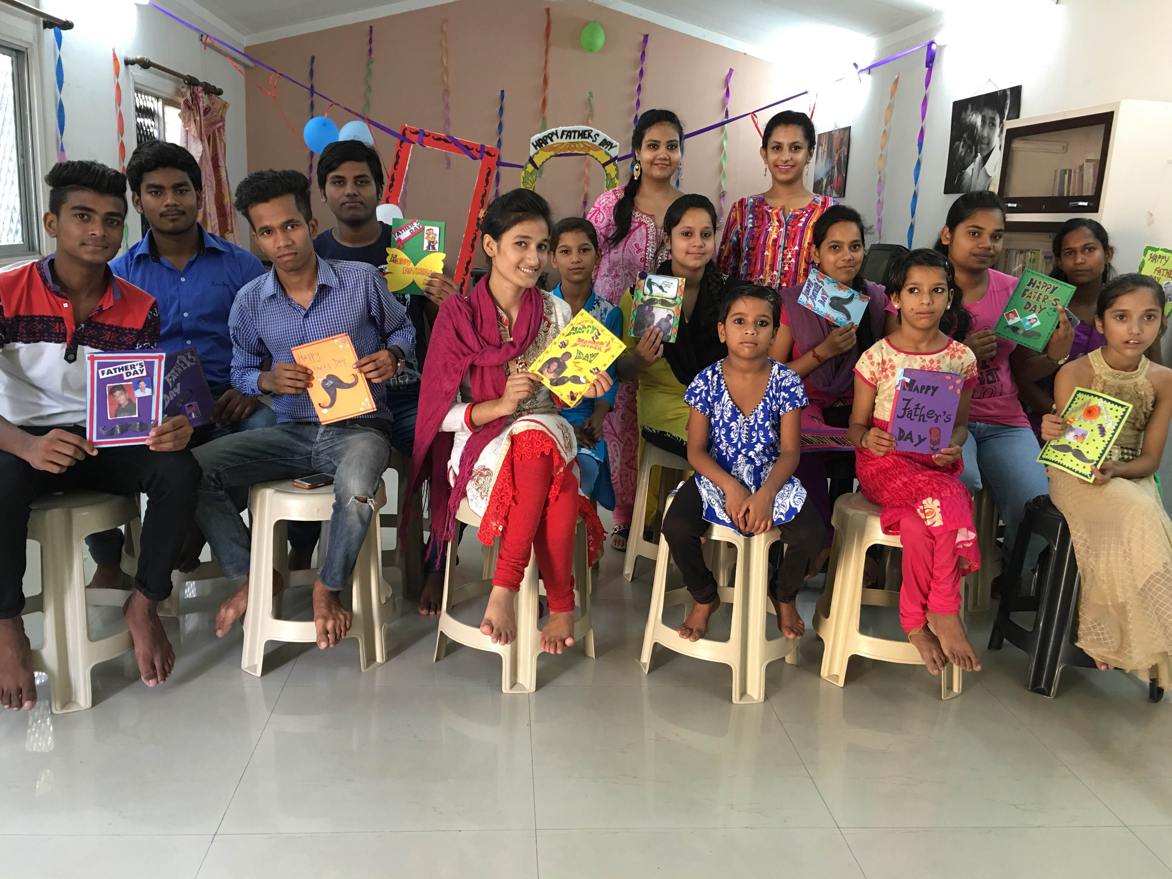 Children proudly showing off the cards they made for their fathers to show gratitude at Kanak Durga.