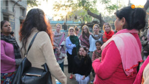 Team interacting with the Mahila Mandal members
