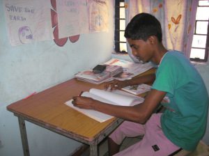 Chandan studying at the Asha’s resource center in Jeevan Nagar slum colony