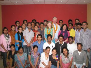 HE and Mrs. Stewart Beck and Dr. Kiran Martin pose for a group photograph with the university students from Asha slums