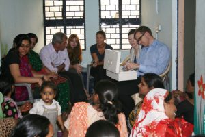 Dr. Nathan Grills examines the contents of a CHV’s medicine box