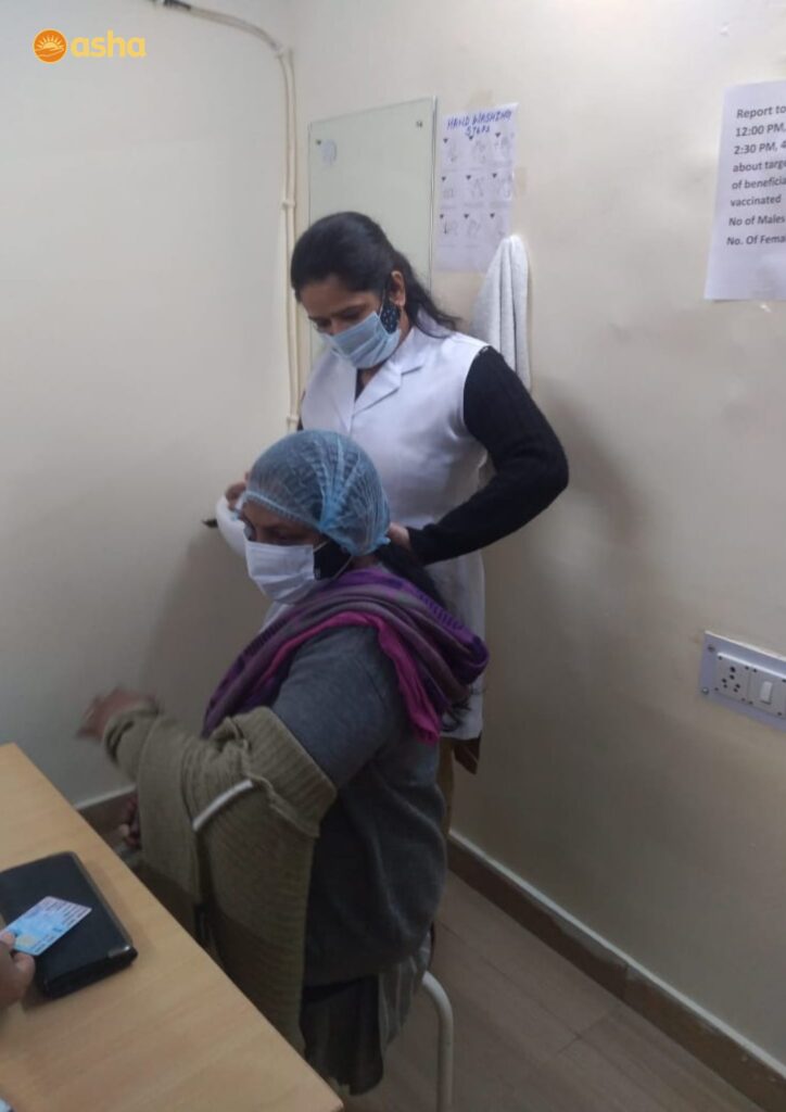 Asha frontline health workers receive their vaccination