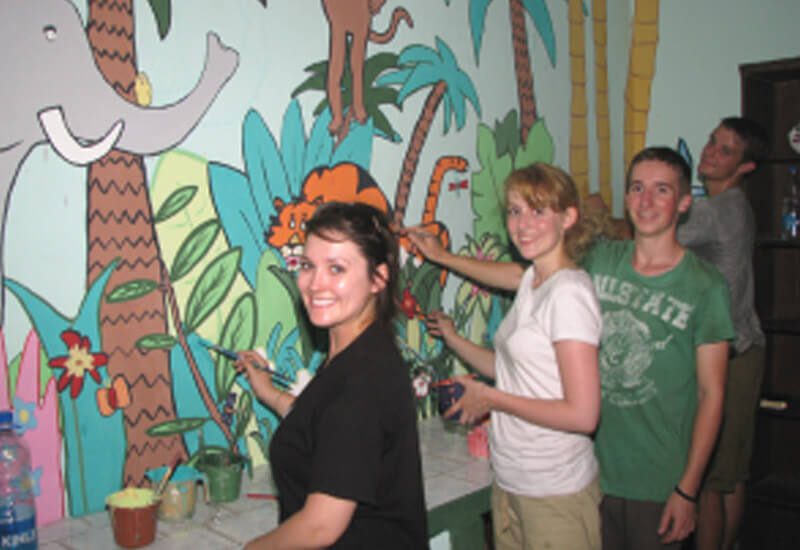 A team of students from the UK paint the Asha centre at Mayapuri slum colony