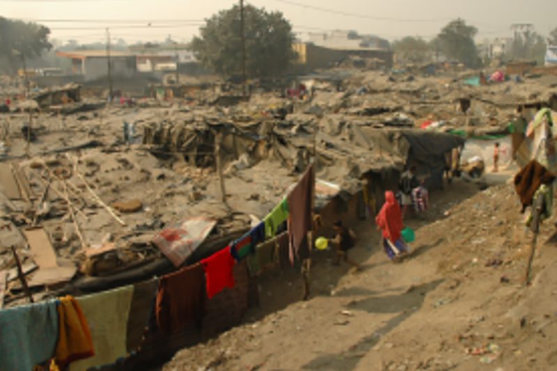 This is a typical slum in Delhi -shanty huts, made of cardboard, plastic sheets and pieces of cloth tightly packed together
