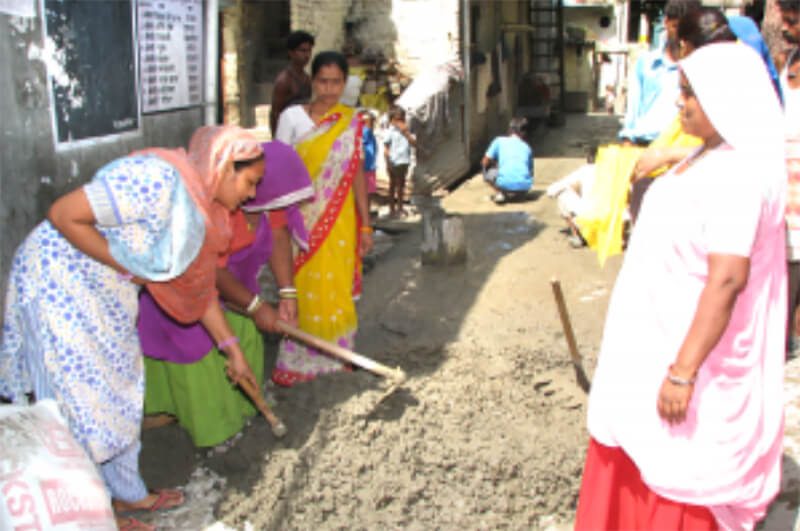 Women in Ekta Vihar take the initiative and pave a damaged road within their area 