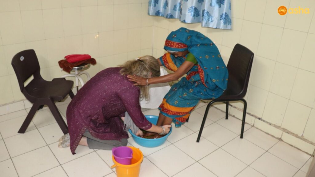 Governing Board members of Friends of Asha, Great Britain, wash the feet of the poor in the Mayapuri Slum Community
